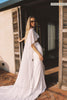 A woman models a sheer cape and a long wedding skirt_XS_