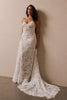woman wearing a white lace backless dress with thin straps and delicate chain jewellery across her back_L_