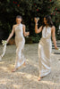 Two women walking in champagne bridesmaid dresses