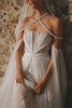 Intricate detailing of a lace wedding dress and accessories against a stone wall_XS_