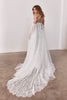 Woman wearing a lace wedding dress with a long train_XS_