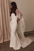 Woman wearing a white wedding dress with a chantilly lace shawl