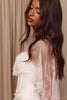 Woman wearing a white wedding dress with a Chantilly lace cape