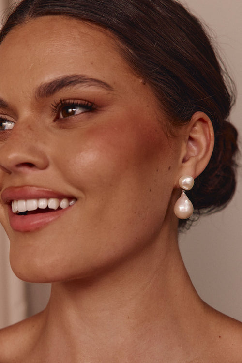 Woman wearing pearl earrings