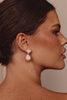 Close-up of a woman wearing pearl earrings