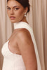 Woman wearing a white dress with pearl earrings