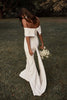 Woman in a garden wearing an off-the-shoulder wedding dress