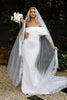 Bride wearing a mantilla veil and crepe wedding dress