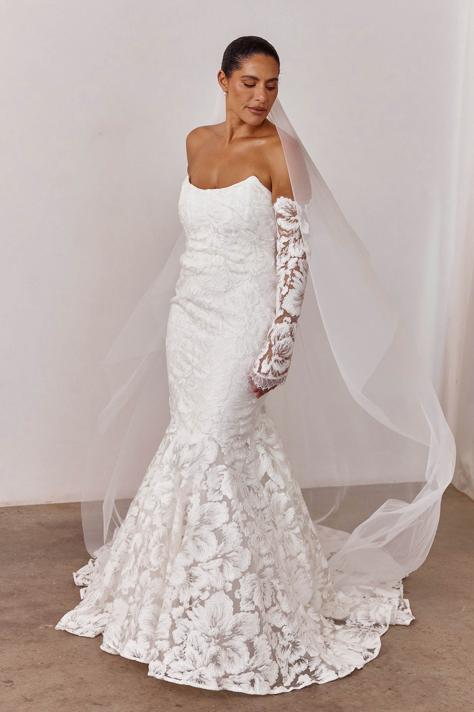 A strapless lace wedding dress with long sleeves and a veil_L_