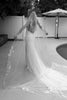 Woman wearing a long veil with floral embroidery