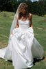Woman wearing a satin A-line wedding dress_XS_