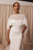 Woman in a wedding dress and sheer bridal cape