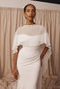 Woman in a wedding dress and sheer bridal cape