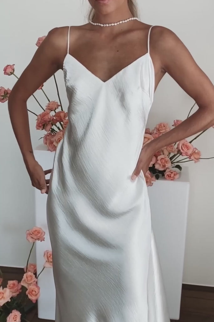 A woman in a satin wedding dress.