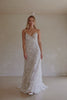 Video of a woman wearing a white lace backless dress with thin straps and delicate chain jewellery across her back_XS_