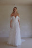 Video of a woman wearing a white off-the-shoulder lace wedding gown with a deep V neckline and a full layered skirt