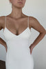 Woman wearing a spaghetti strap crepe wedding dress.