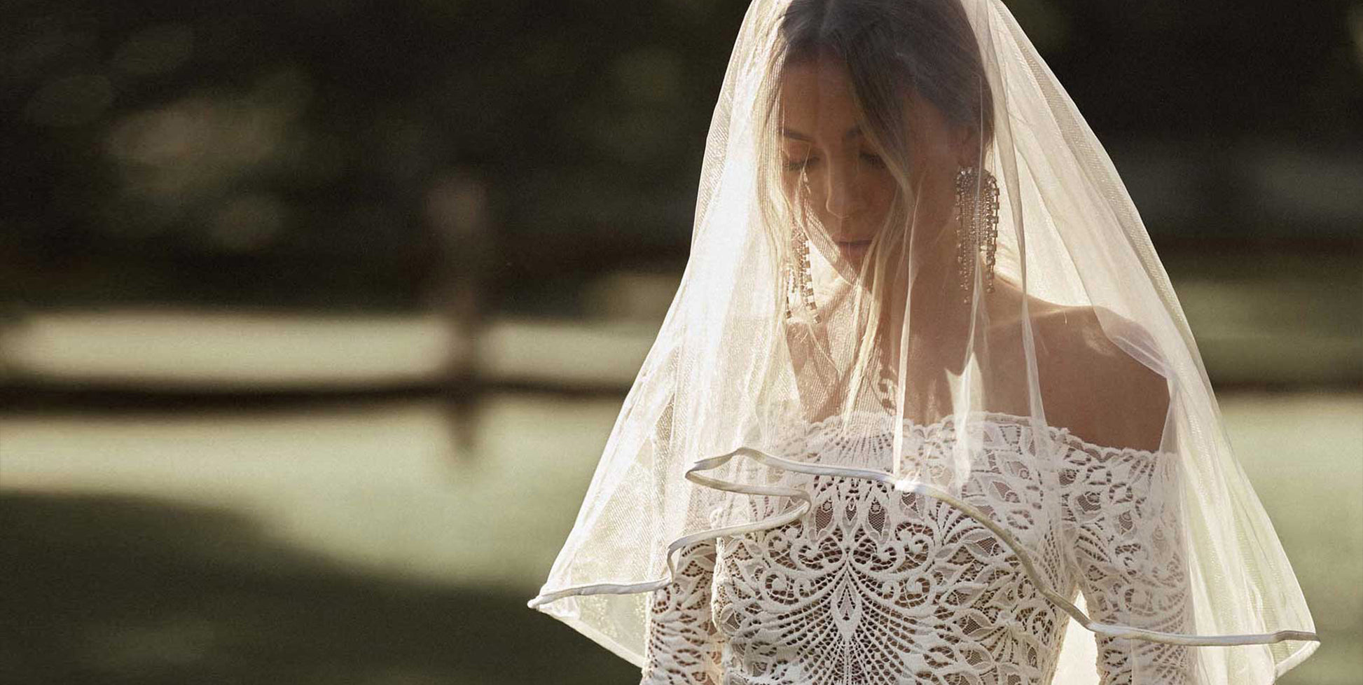Woman wearing a blusher veil and wedding dress.