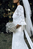 3/4 sleeve of Filamena gown with bride holding bouquet